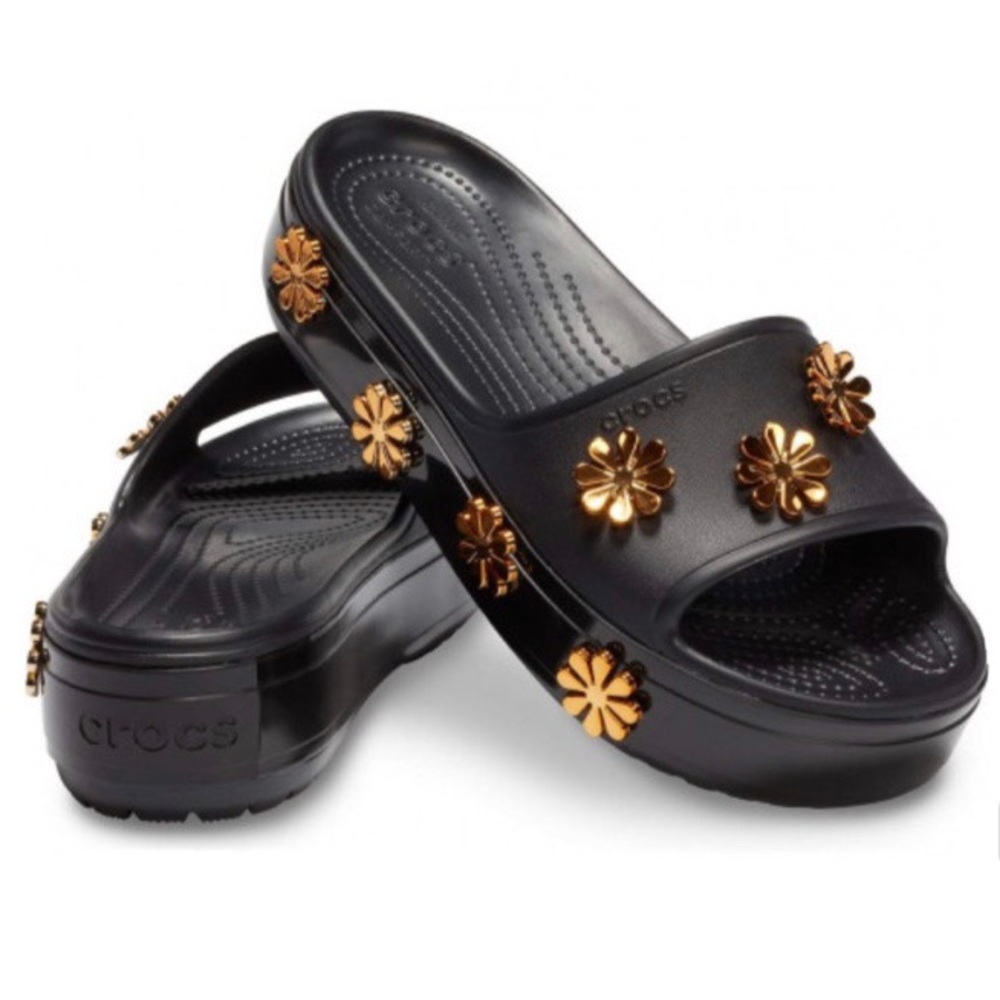 Crocs platform slippers with metallic flowers.